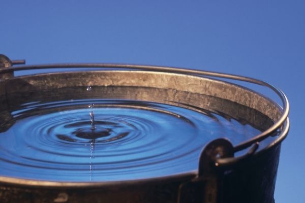 Earth Day- A drop of water falling into a bucket of water