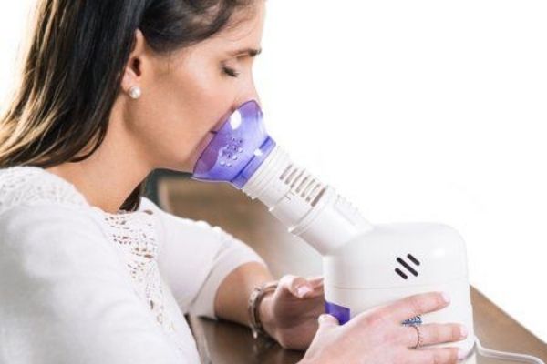 Self-isolation checklist: A woman inhaling steam using a steam inhaler/vaporizer