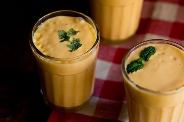 Mango lassis topped with mint leaves