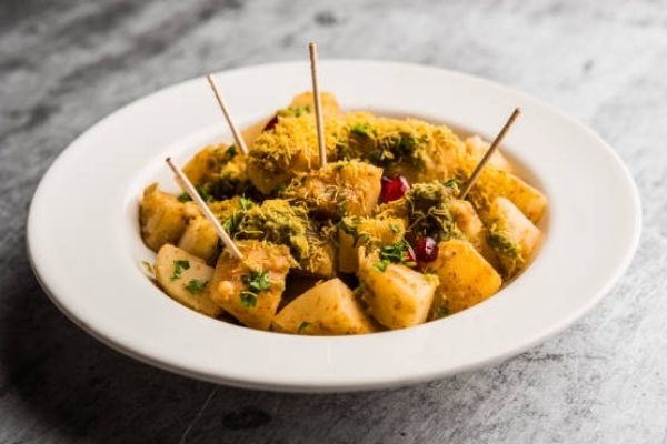 A plate of fresh aloo chaat with some toothpicks